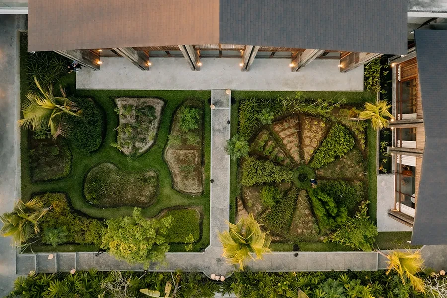 An overhead bird's-eye view of the geometric edible gardens and sustainable architecture at Syrco BASE Restaurant and bar.