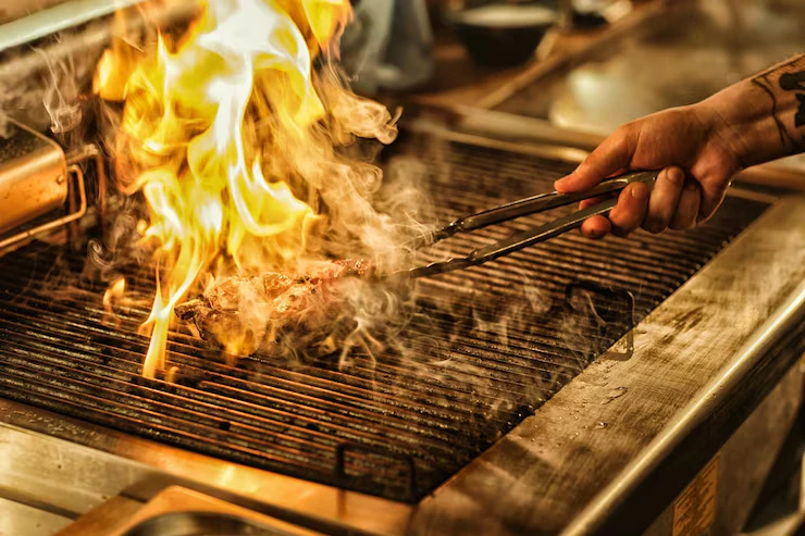 Premium steak seared over an open flame at a Bali Restaurant and Cafe Association woodfire grill.