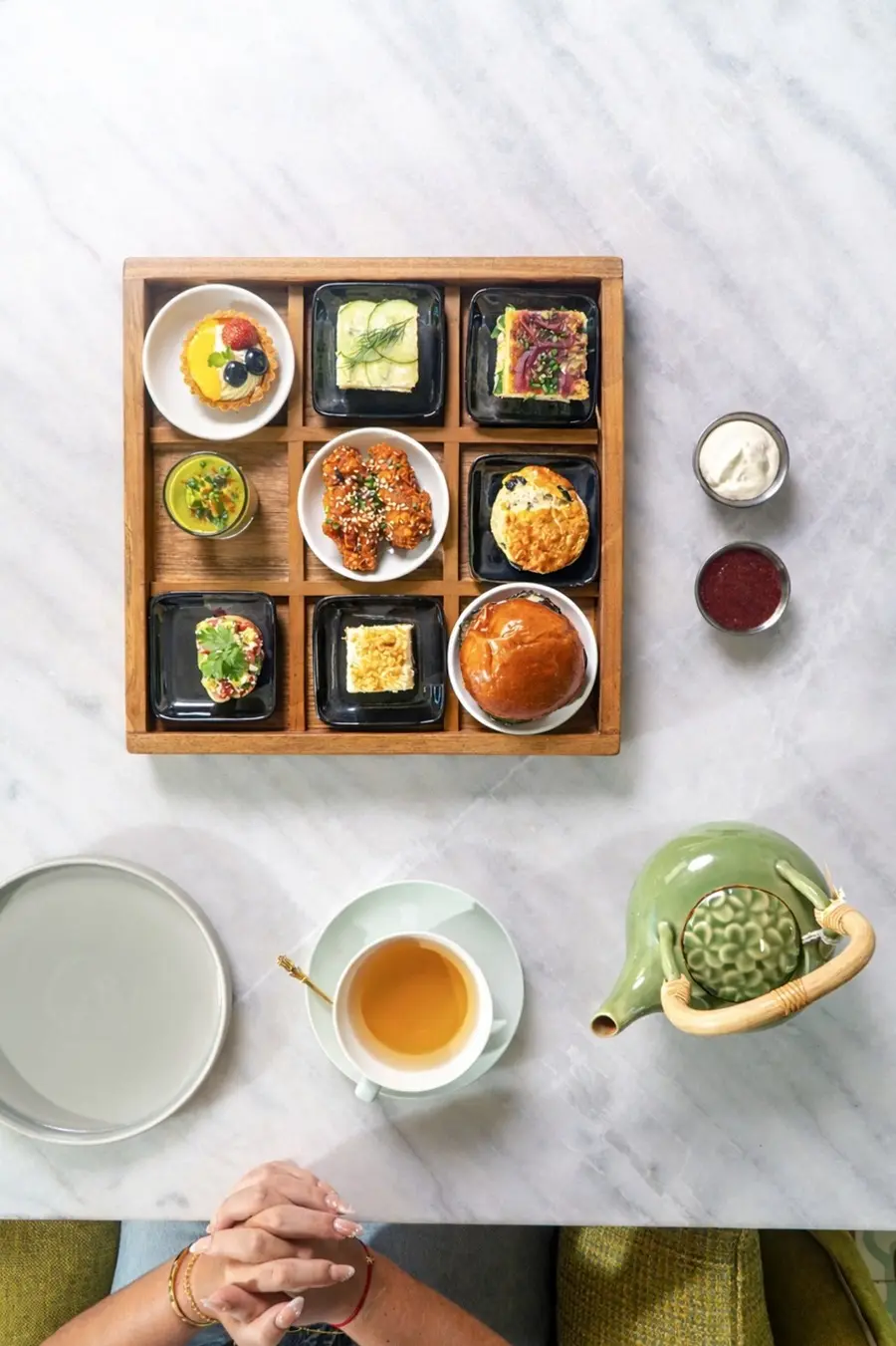 Overhead view of tea and assorted small dishes.