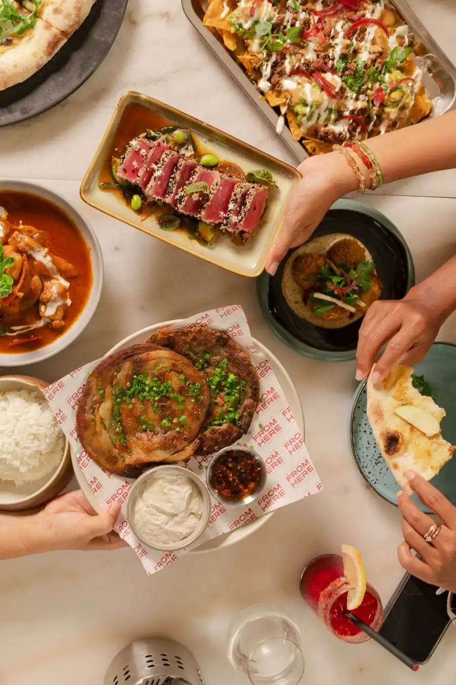 People sharing restaurant dishes.