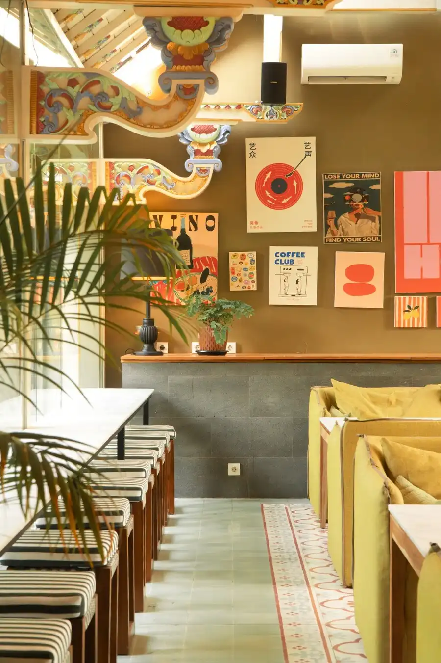 Cafe interior with long marble counter and yellow seating