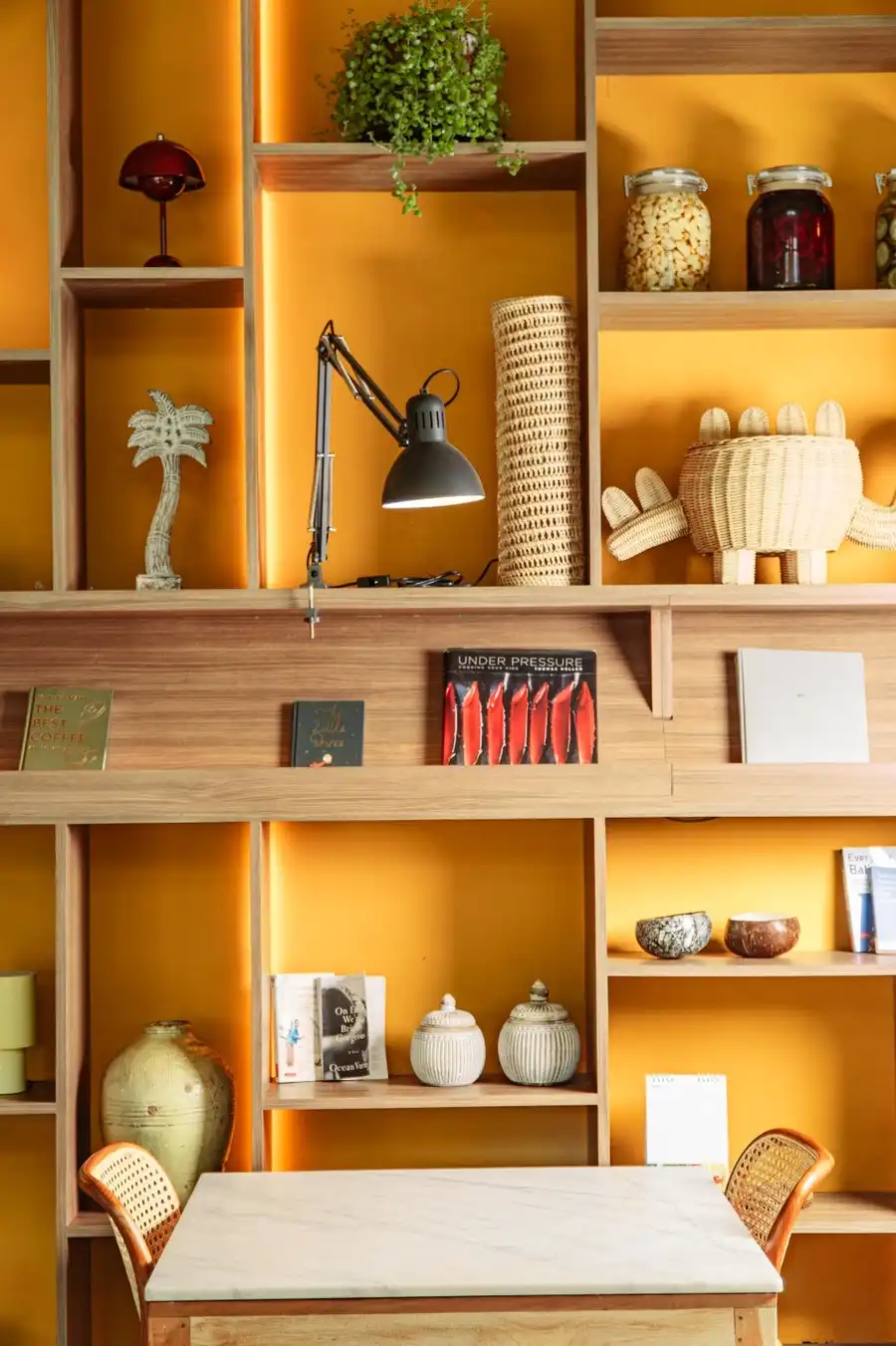 Cozy dining table next to an illuminated wooden display shelf