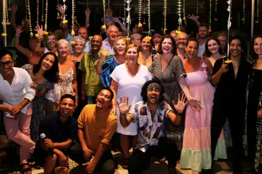Large group of smiling people posing at a party